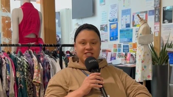 Student speaking into a microphone while seated in a pink chair at Glasgow Kelvin College, with racks of clothing and mannequins in the background Student speaking into a microphone while seated in a pink chair at Glasgow Kelvin College, with racks of clothing and mannequins in the background